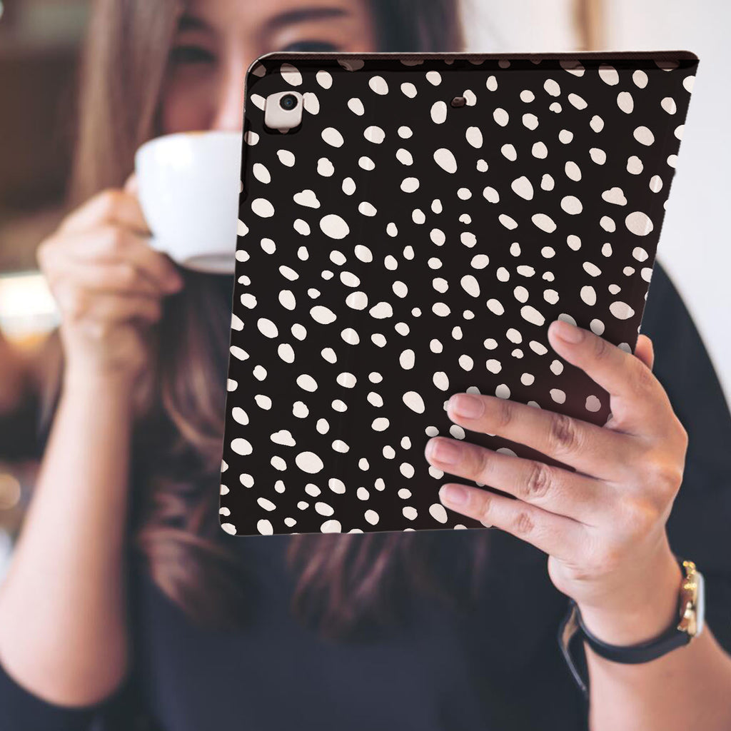 a girl is holding and viewing personalized iPad folio case with Polka Dot design