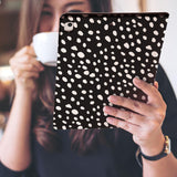 a girl is holding and viewing personalized iPad folio case with Polka Dot design