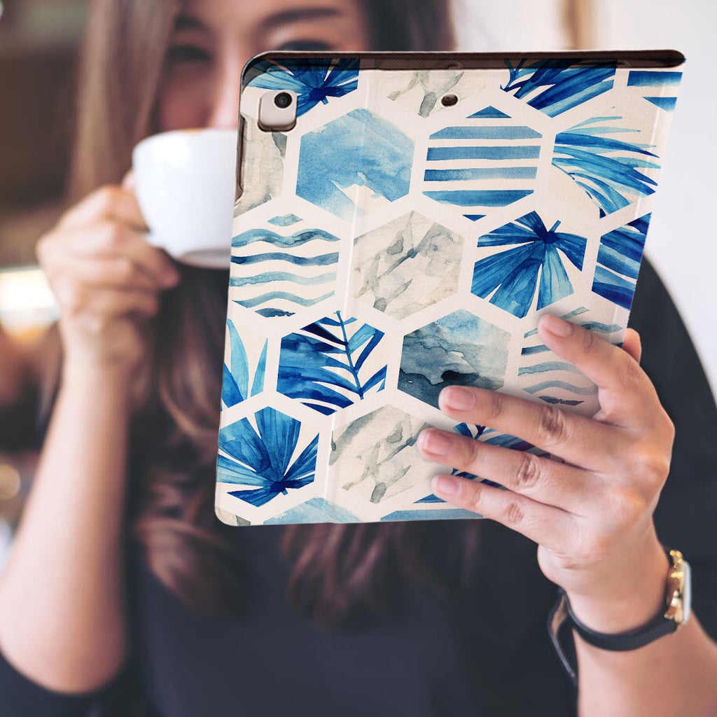 a girl is holding and viewing personalized iPad folio case with Geometric Flower design