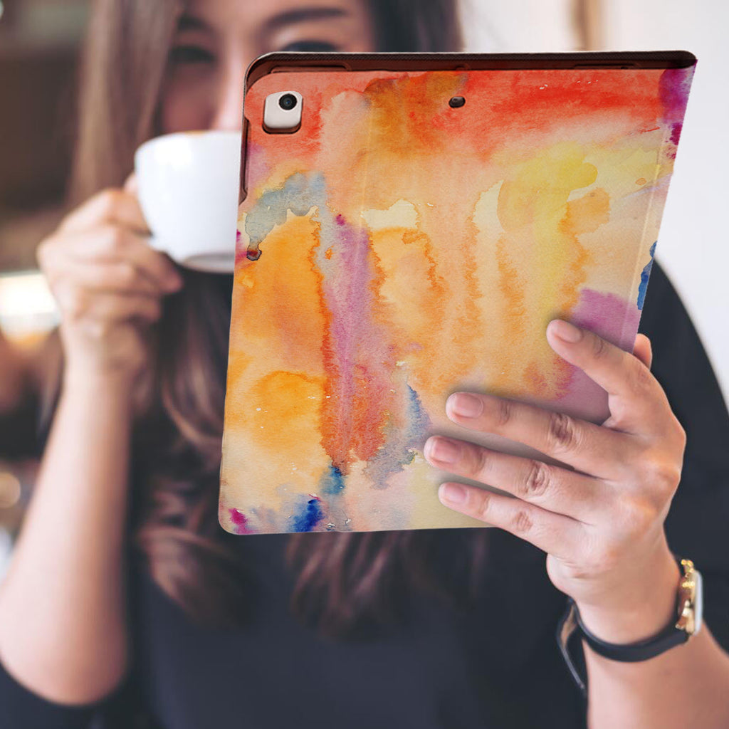 a girl is holding and viewing personalized iPad folio case with Splash design